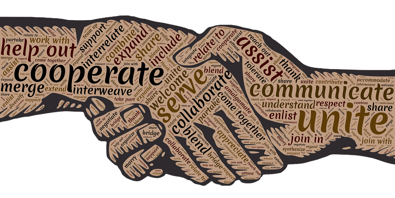 Drawn image of two hands haking with 'cooperation' messages covering both
